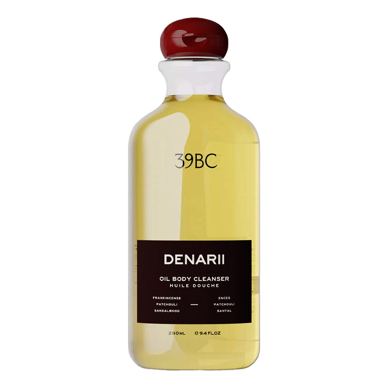 Bottle of Denarii oil body cleanser with a red cap on a white background