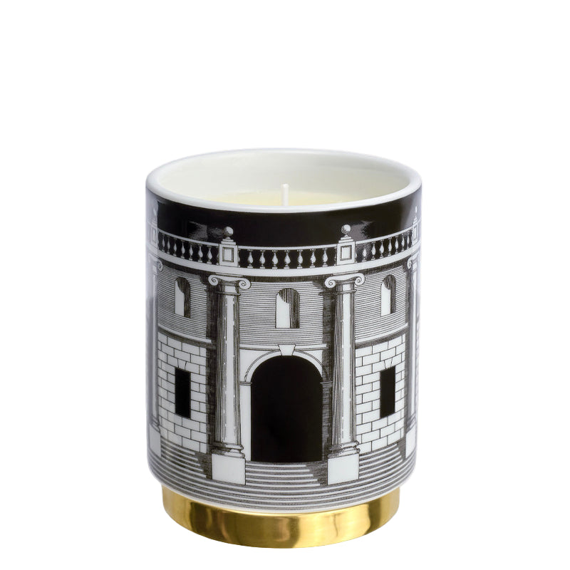 Candle in a decorative container with architectural design on a white background