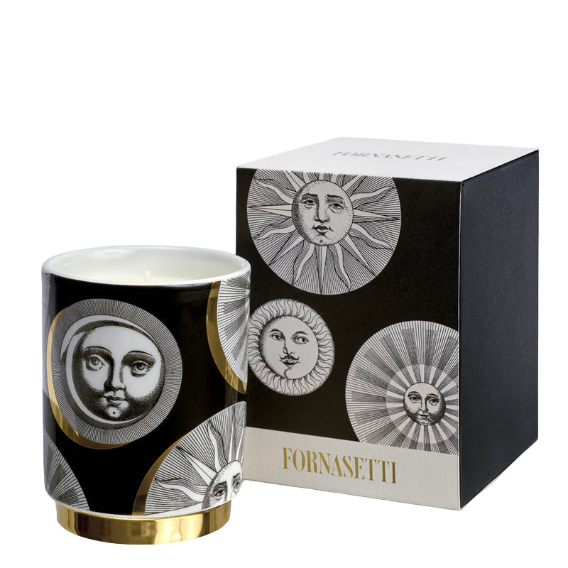 Fornasetti candle with decorative packaging on a white background