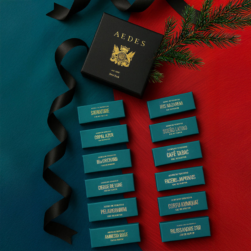 Collection of Aedes sample boxes with gold text on a red and blue gradient background, featuring the brand 'Aedes'.