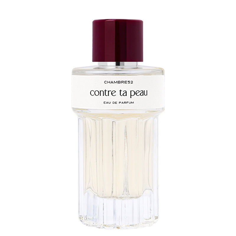 Perfume bottle labeled 'contre ta peau' by Chambre52 on a white background
