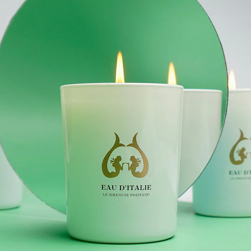 White candle with 'Eau d'Italie' logo on a green background