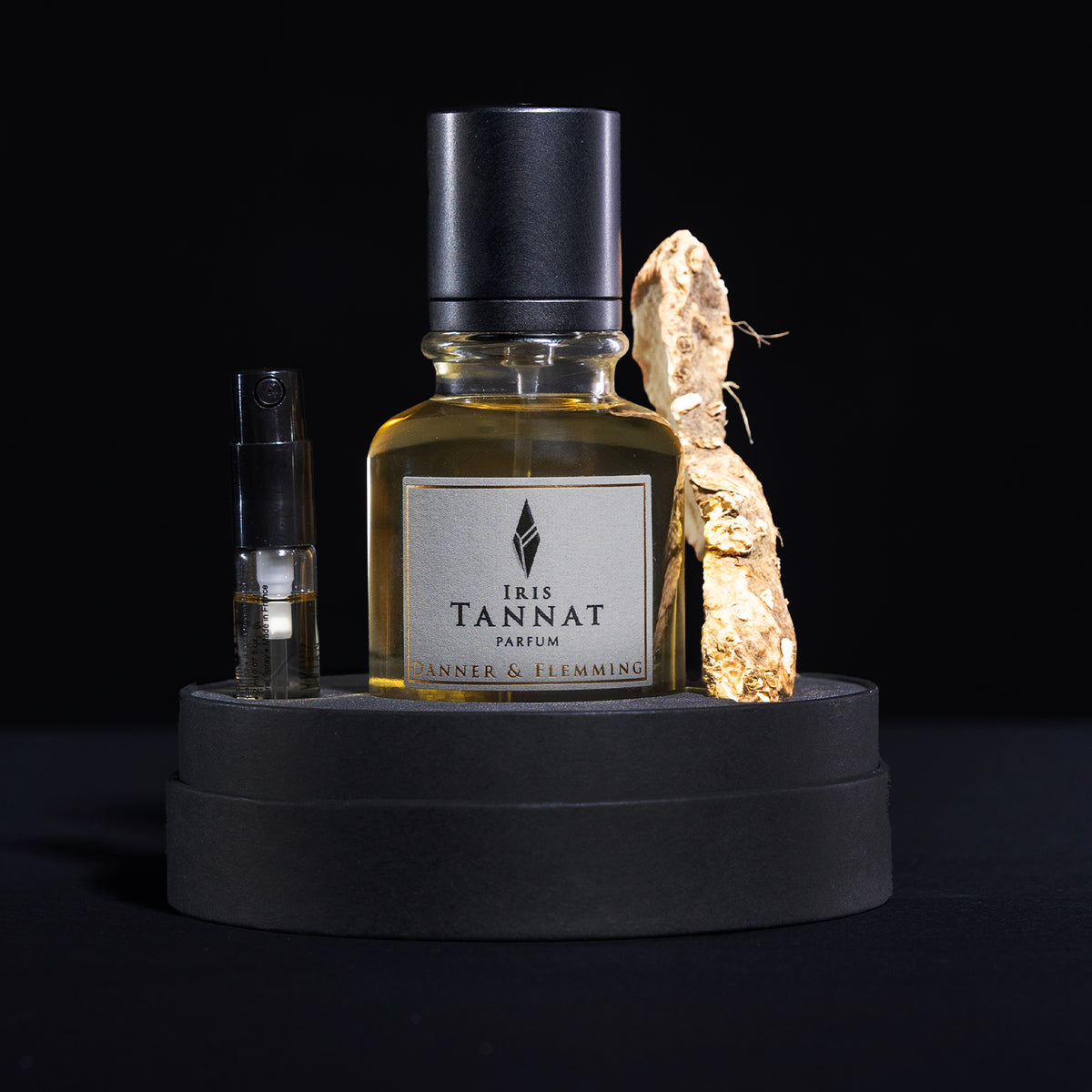 Iris Tannat flacon in box alon with an iris root and an iris extrait vial.