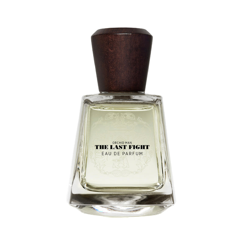 A bottle of 'The Last Fight' Eau de Parfum by Declosur, featuring a clear glass bottle with a dark brown wooden cap, set against a plain white background. Orchid Man The Last Fight - Eau de Parfum | Frapin | AEDES.COM