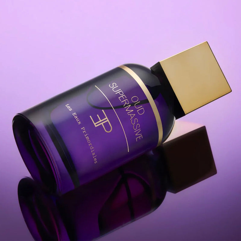 Purple bottle with gold cap on a purple background. Oud Supermassive - Extrait de Parfum | Les Eaux Primordiales | AEDES.COM