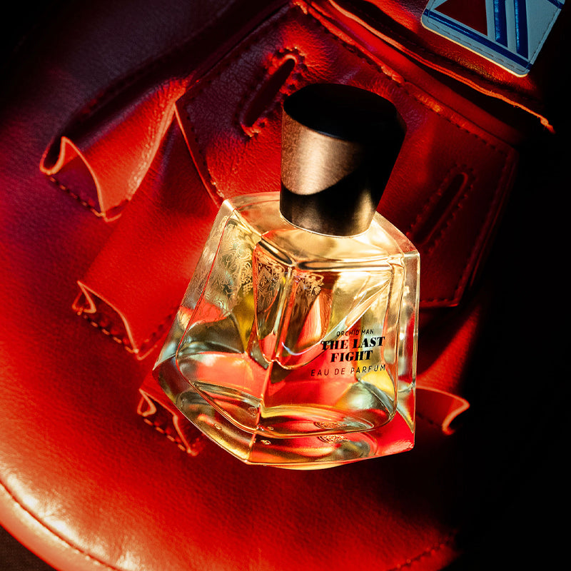 Orchid Man The Last Fight EdP 3.4oz flacon with wooden cap displayed in a red boxing glove.