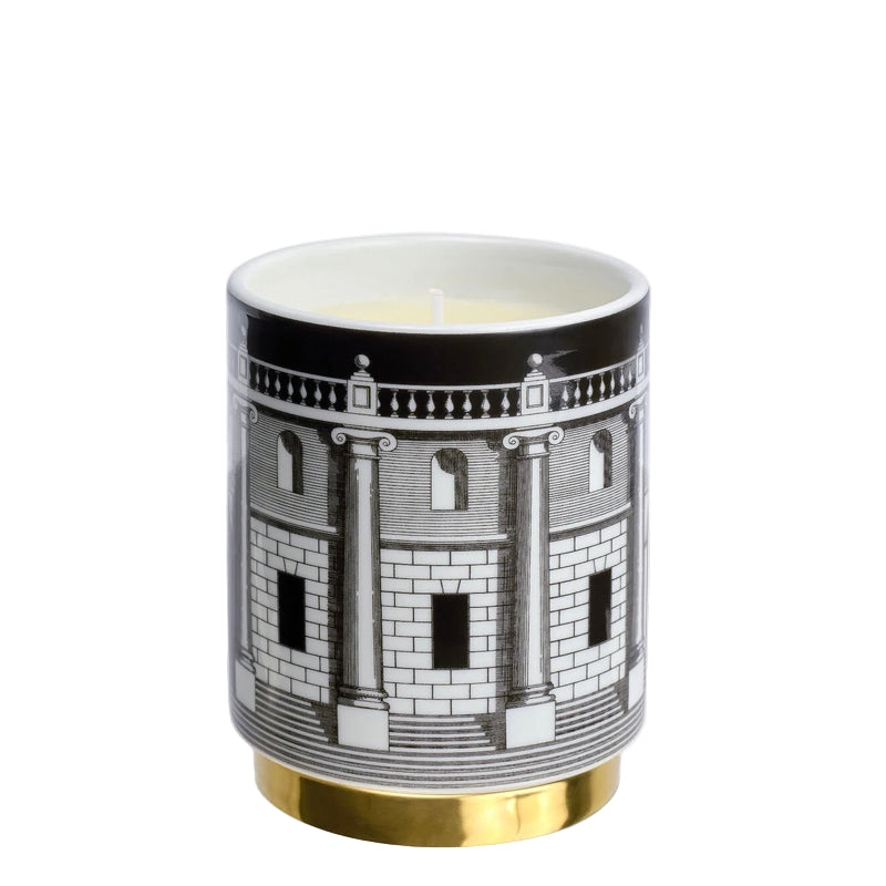 Candle in a decorative container with architectural design on a white background