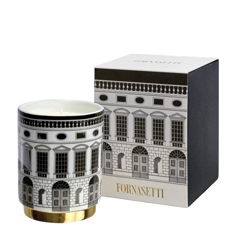 Fornasetti candle with decorative packaging on a white background
