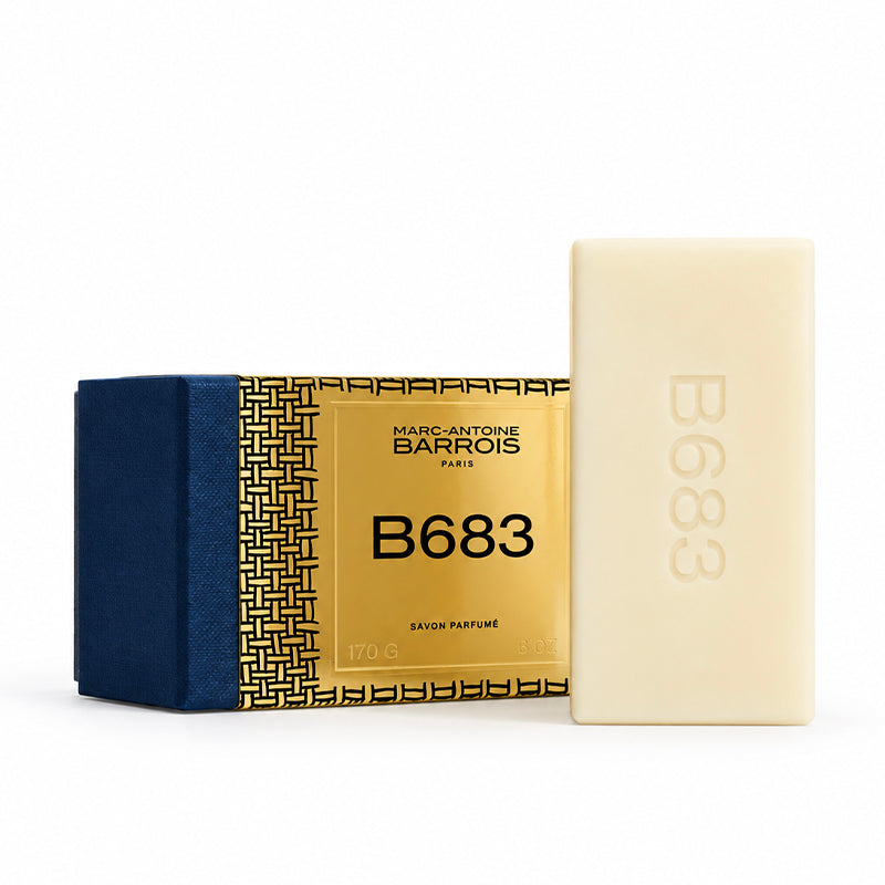 Marc-Antoine Barrois B683 Sâvour Parfumé, showing a cream-colored rectangular bar of soap next to its gold and navy blue packaging box on a white background.