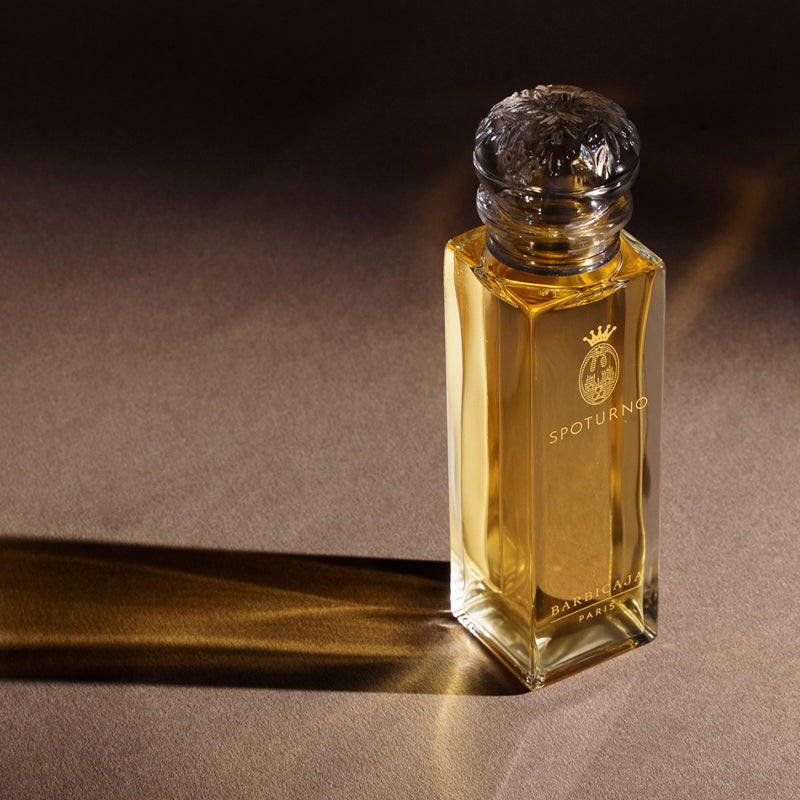 Perfume bottle with 'Spoturno' branding on a dark background