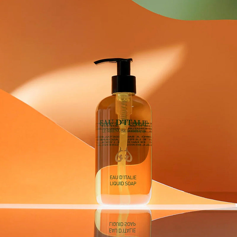Bottle of EAU D'ITALIE liquid soap on a warm-toned background
