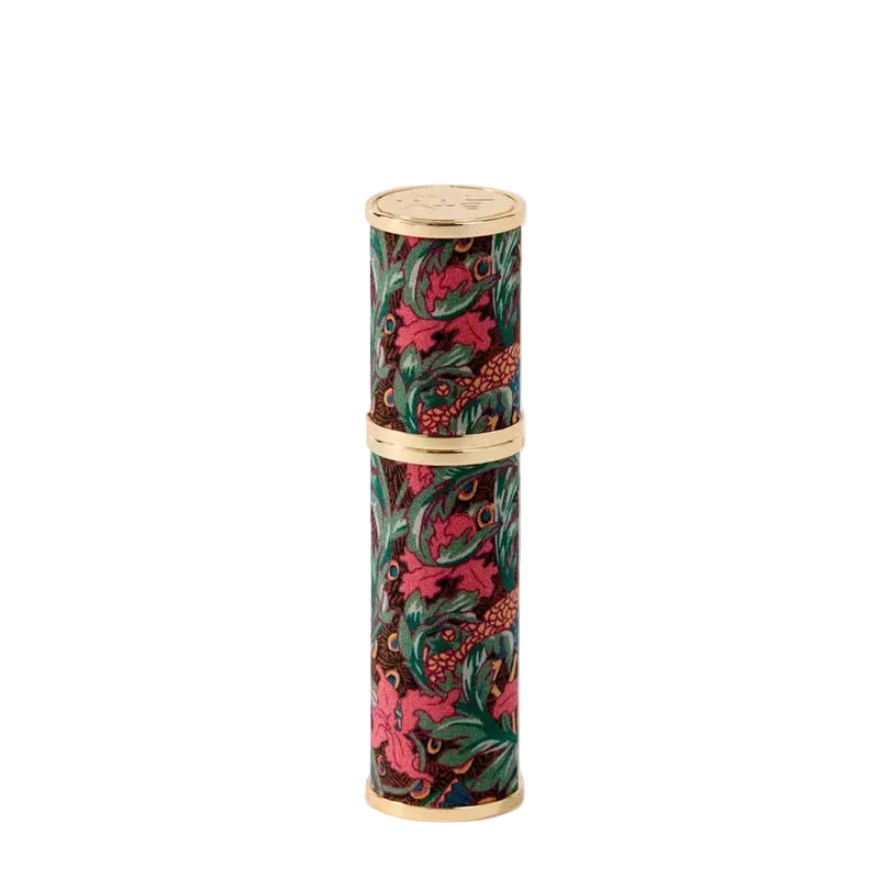 Decorative cylindrical travel atomizer by Liberty London with floral pattern on a white background