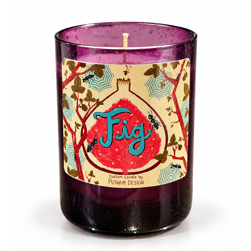 Fig scented candle in purple glass container with colorful illustration on the label reading Fig Custom Candle by Putnam Design.
