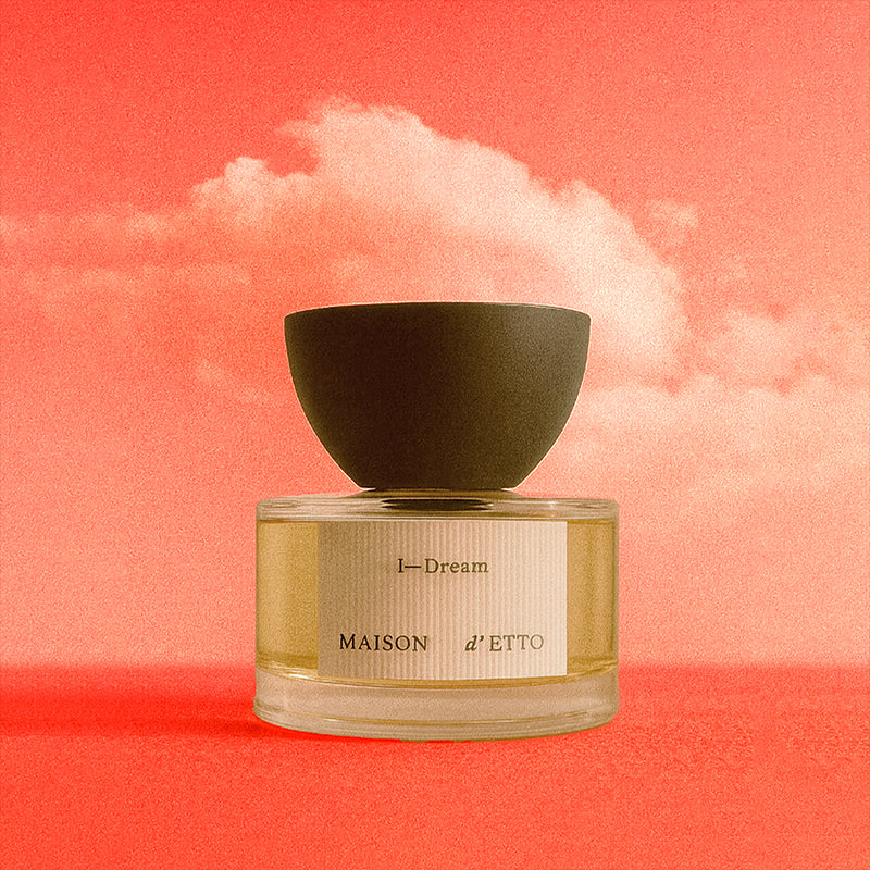 Maison d'Etto I-Dream Perfume bottle with a green cap on a pink background