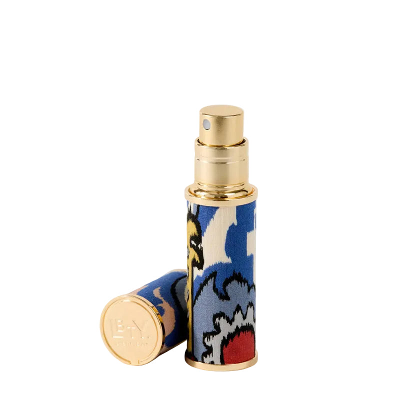 Liberty Beauty's colorful cylindrical travel atomizer that is refillable with a patterned design on a white background