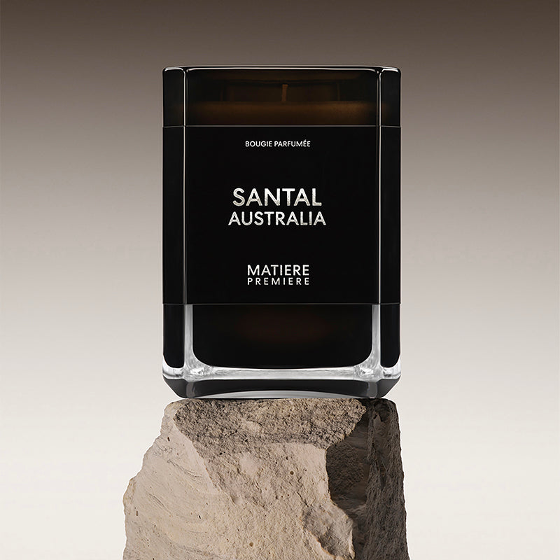 Black and clear container labeled 'Santal Australia' on a stone surface with a gradient background by Matiere Premiere