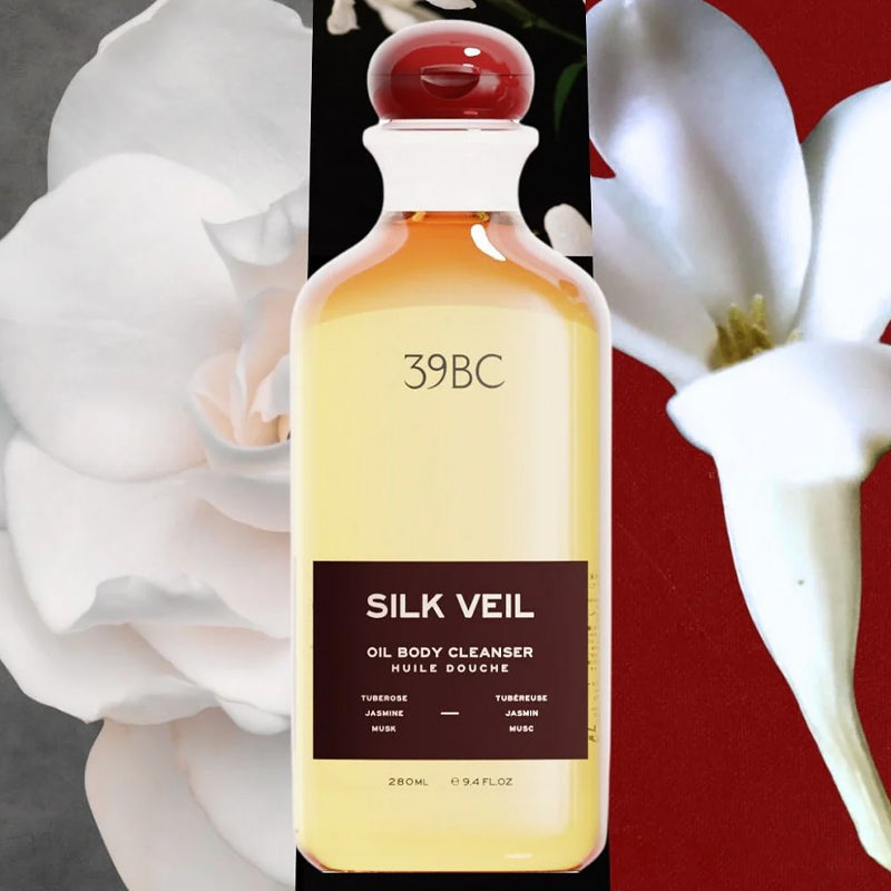 Bottle of 39BC Silk Veil Oil Body Cleanser with flowers in the background