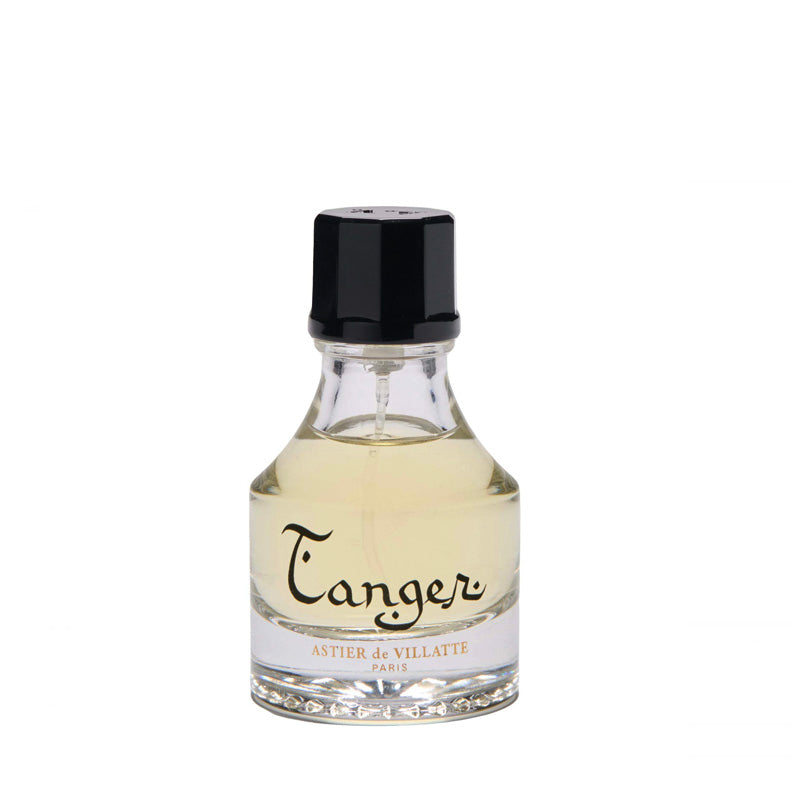 A small 1oz or 30ml clear glass bottle of Astier de Villatte Paris Tanger Eau de Toilette with pale yellow liquid, a black cap, and a white label with black script.