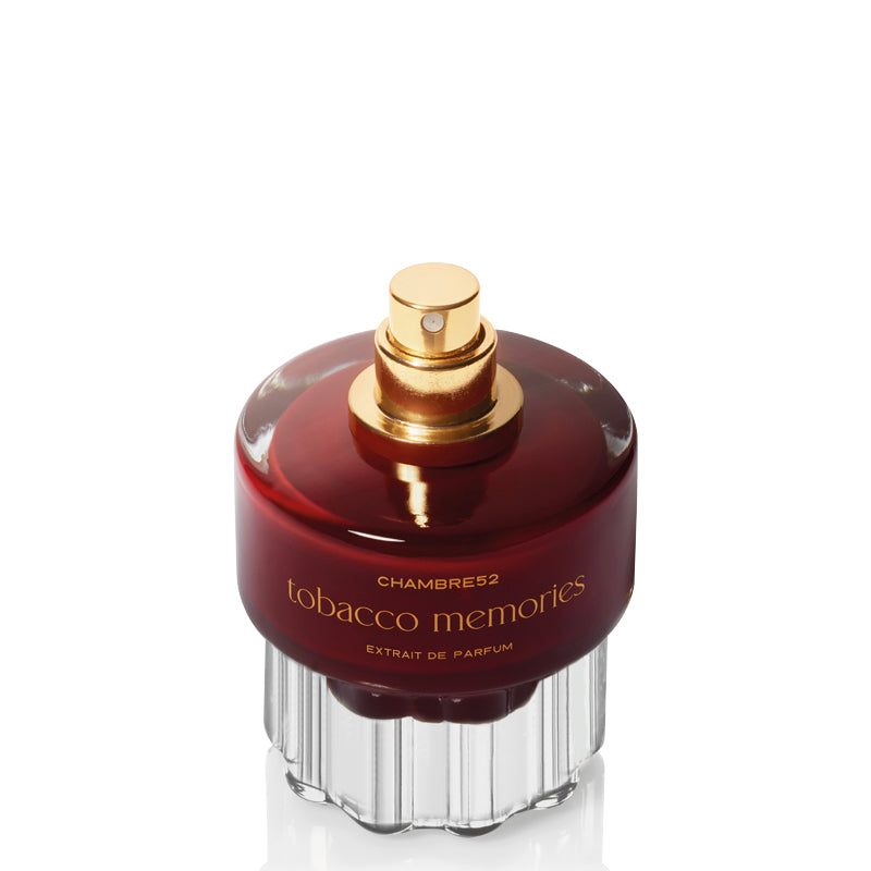 Chambres2 Tobacco Memories Extrait de Parfum bottle, featuring a dark amber-brown glass body, a gold spray nozzle, and a clear ribbed glass base, set against a plain white background. Tobacco Memories - Extrait de Parfum | Chambre 52 | AEDES.COM